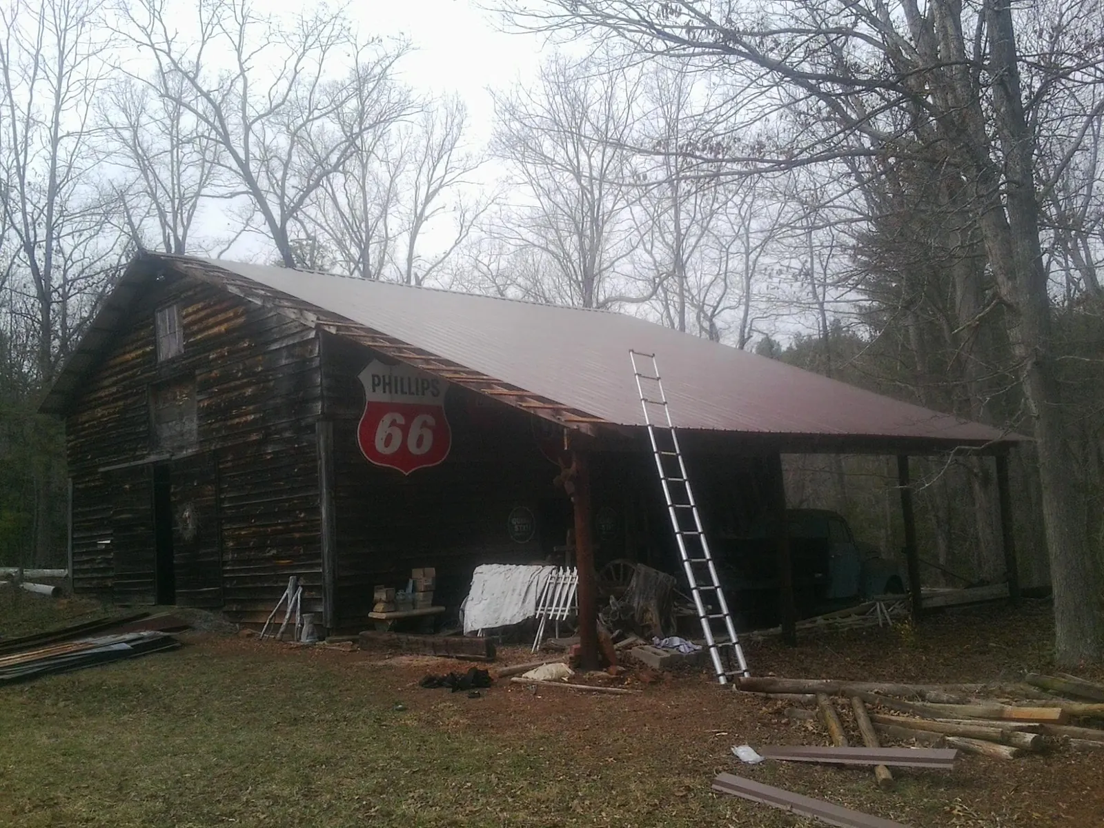 New metal roof on an open sided timber barn with a vintage sign in Rochelle